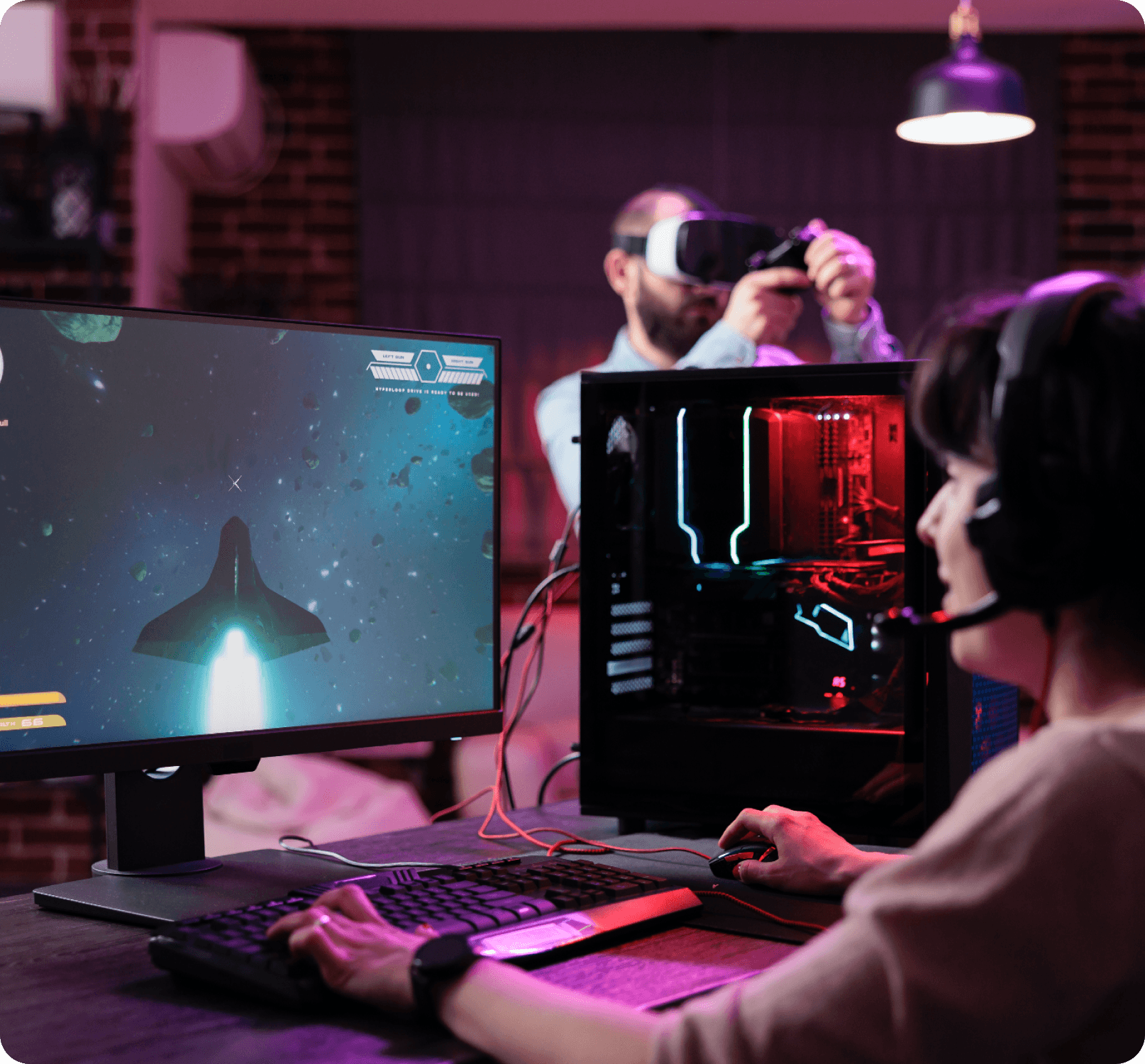 Person gaming with headset, computer, and VR headset, displaying language options on screen.