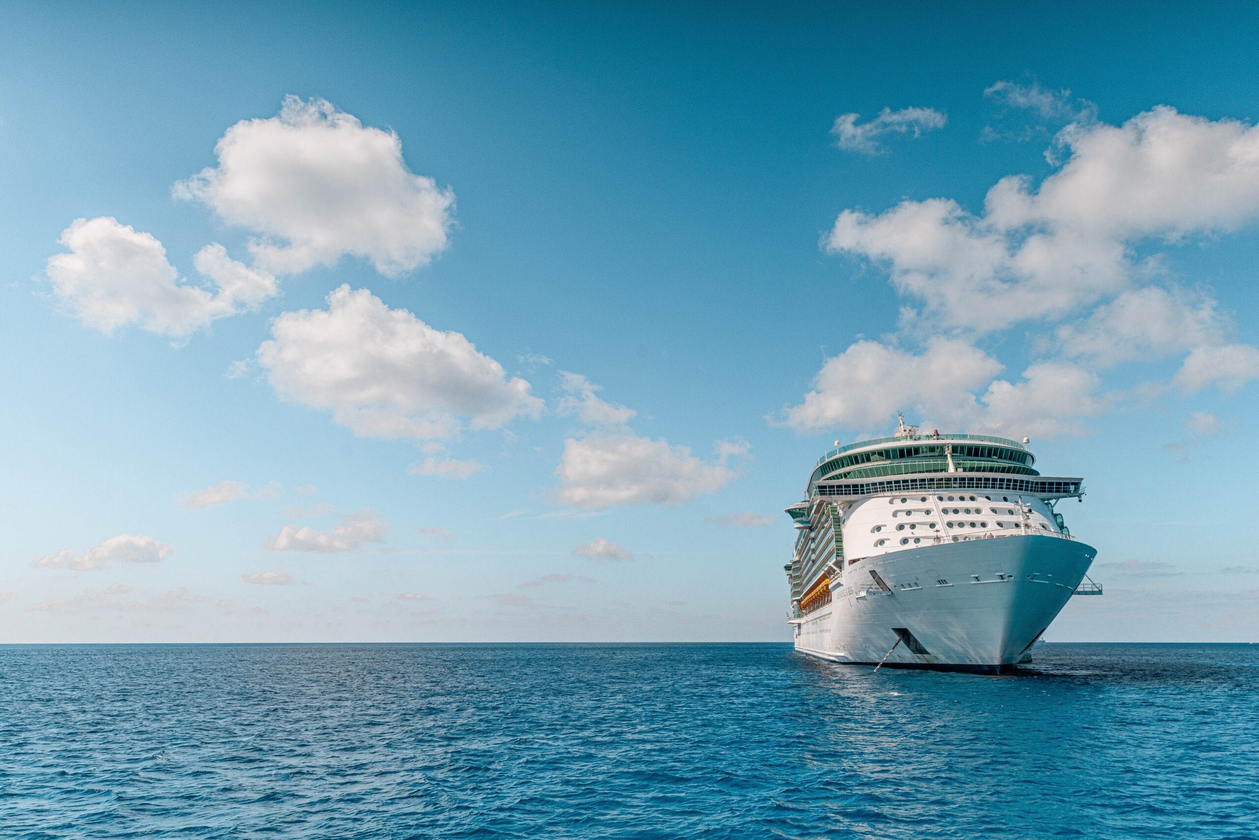 A cruise ship at sea under a blue sky