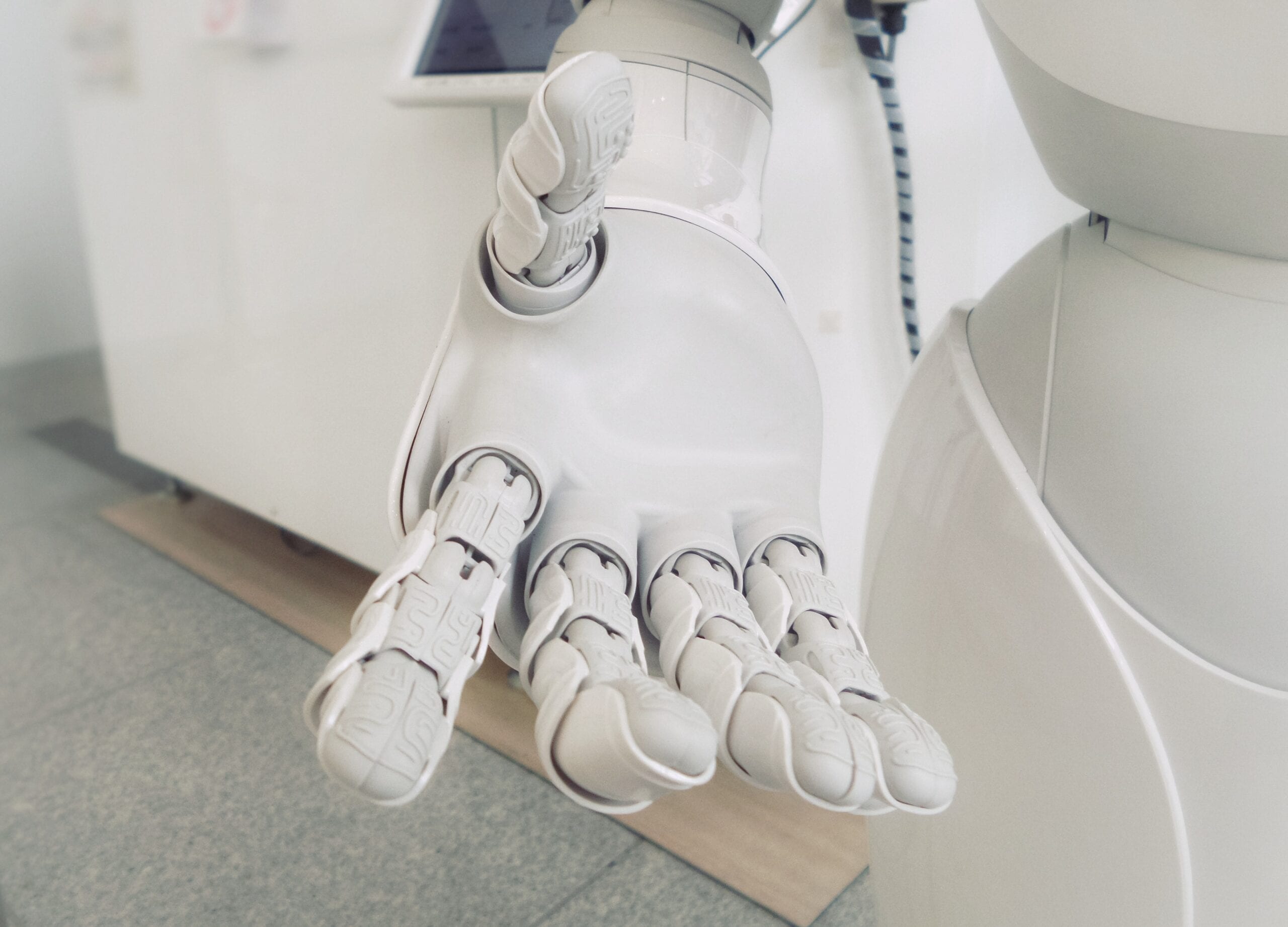 The hand of a white humanoid robot