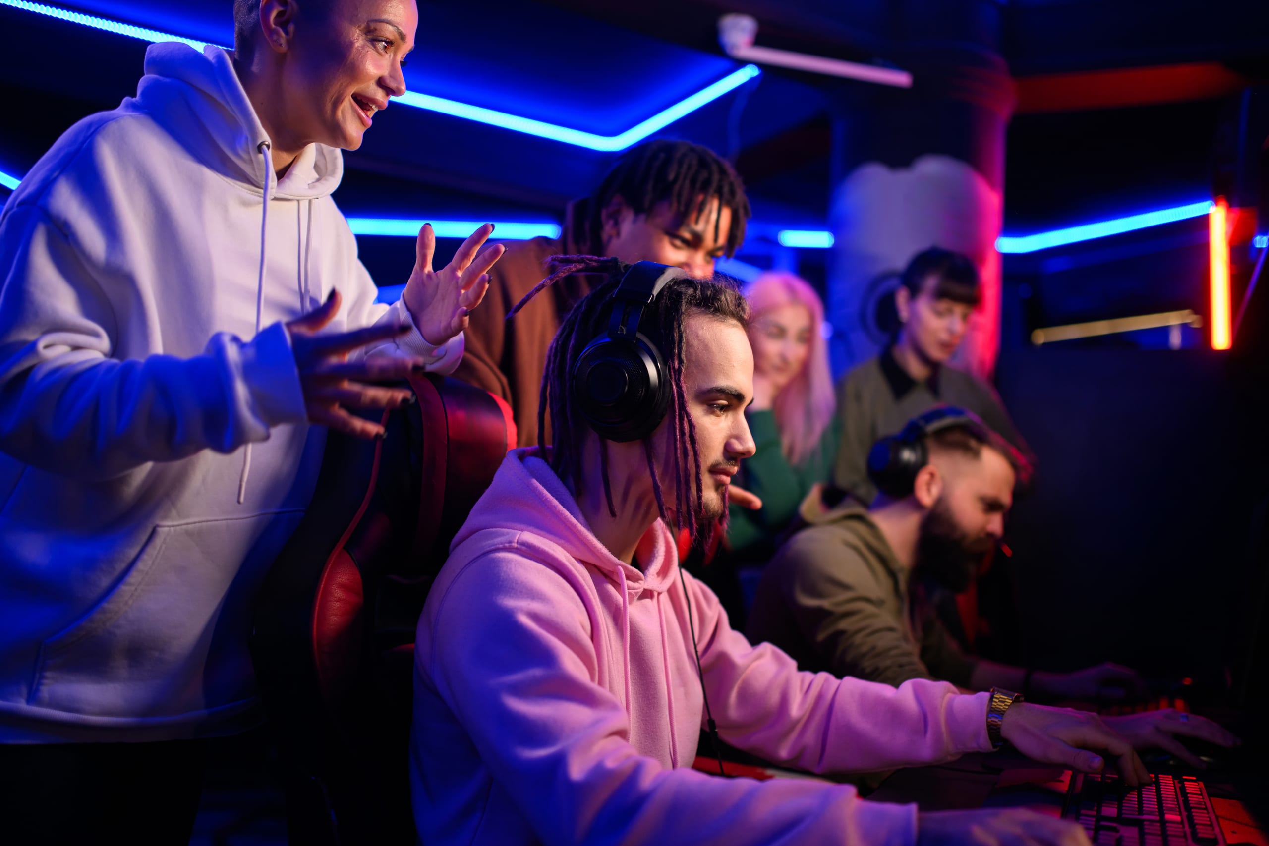 Pro eSports gamer diverse team playing online strategy video game.