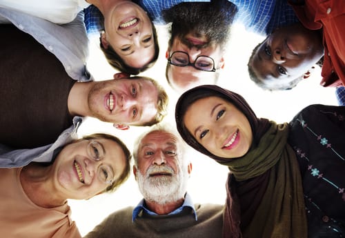 Concept of ReadSpeaker multilingual Neural TTS expressed via image of people of different cultures in a circle looking down ,