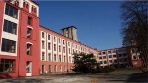 Photo of the outside of a PUW university building, with blue sky overhead.